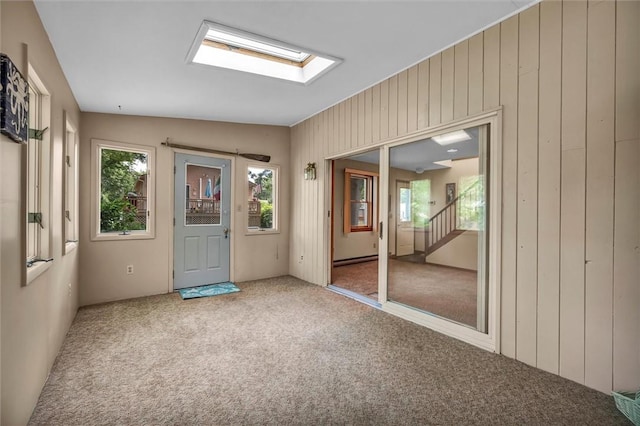146 Balsam Rd, South Kingstown, RI 02879 - entrance foyer with carpet, wooden walls, and a skylight