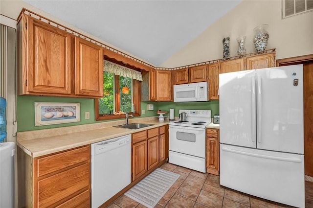 146 Balsam Rd, South Kingstown, RI 02879 - kitchen featuring white appliances, vaulted ceiling, light tile patterned flooring, light countertops, and brown cabinetry