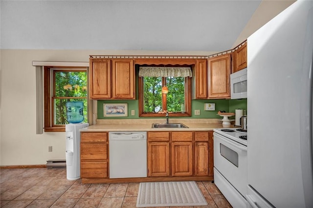 146 Balsam Rd, South Kingstown, RI 02879 - kitchen featuring white appliances, vaulted ceiling, healthy amount of natural light, light countertops, and brown cabinetry