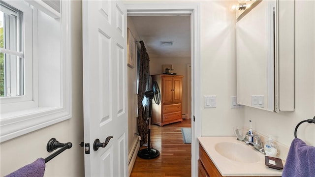 24 Mello St, West Warwick, RI 02893 - bathroom with vanity, wood finished floors, and a baseboard radiator