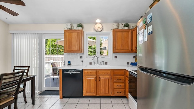 24 Mello St, West Warwick, RI 02893 - kitchen with freestanding refrigerator, black dishwasher, light countertops, and healthy amount of natural light