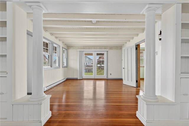 1 Barney Ave, South Kingstown, RI 02879 - unfurnished living room with ornate columns, baseboard heating, wood finished floors, and beam ceiling