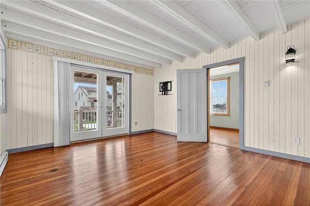 1 Barney Ave, South Kingstown, RI 02879 - unfurnished room featuring wood-type flooring, plenty of natural light, beam ceiling, french doors, and wooden walls