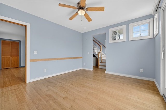1 Barney Ave, South Kingstown, RI 02879 - empty room featuring stairway, wood finished floors, and ceiling fan