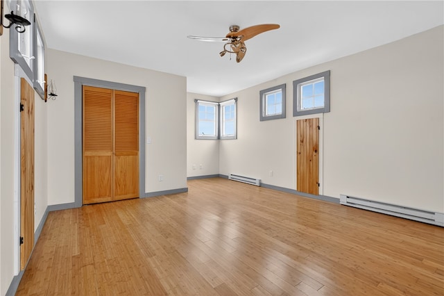 1 Barney Ave, South Kingstown, RI 02879 - unfurnished bedroom featuring light wood-style floors, a baseboard heating unit, and a closet