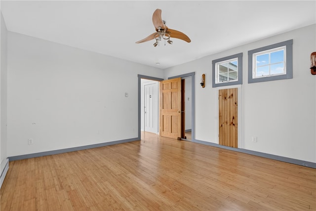 1 Barney Ave, South Kingstown, RI 02879 - empty room featuring light wood-style flooring, a ceiling fan, and a baseboard heating unit