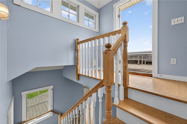 1 Barney Ave, South Kingstown, RI 02879 - stairway with healthy amount of natural light, a towering ceiling, and wood finished floors