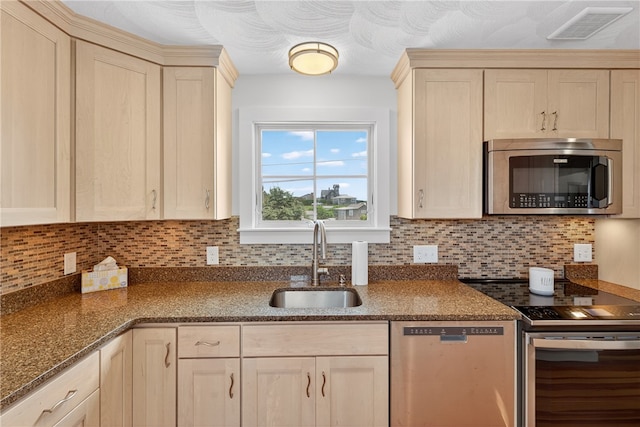 1 Barney Ave, South Kingstown, RI 02879 - kitchen with appliances with stainless steel finishes, backsplash, dark stone countertops, and light brown cabinets