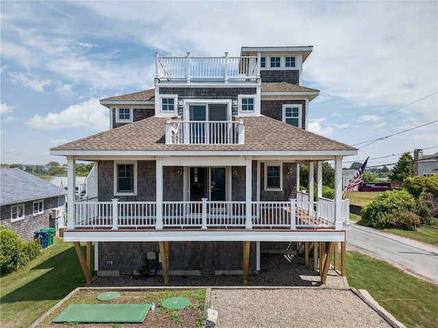 1 Barney Ave, South Kingstown, RI 02879 - view of front of property with a balcony, a porch, a shingled roof, and a front lawn