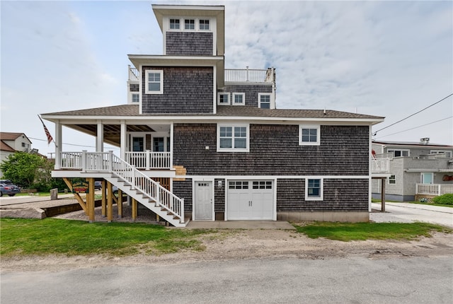 1 Barney Ave, South Kingstown, RI 02879 - rear view of property featuring covered porch, stairway, a garage, and a shingled roof