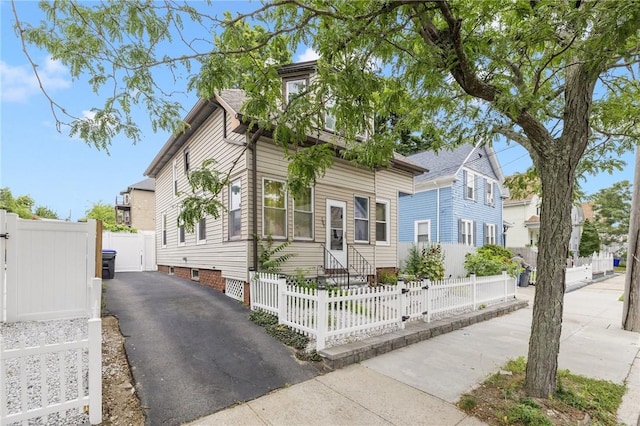 155 Early St, Providence, RI 02907 - view of front of home featuring a gate, asphalt driveway, entry steps, and a fenced front yard