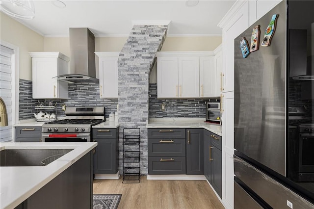 155 Early St, Providence, RI 02907 - kitchen featuring stainless steel appliances, wall chimney range hood, white cabinets, gray cabinets, and crown molding