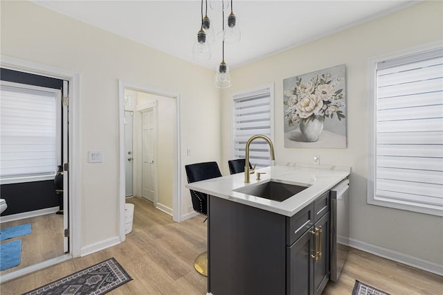 155 Early St, Providence, RI 02907 - kitchen featuring light wood-style flooring, hanging light fixtures, a peninsula, and stainless steel dishwasher