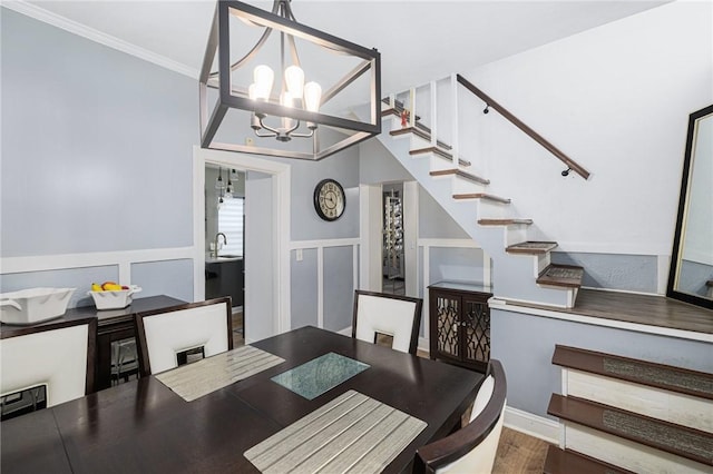 155 Early St, Providence, RI 02907 - dining space featuring stairs, a chandelier, wood finished floors, ornamental molding, and a wainscoted wall