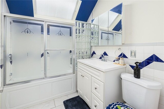155 Early St, Providence, RI 02907 - full bathroom with vanity, enclosed tub / shower combo, marble finish flooring, tile walls, and wainscoting
