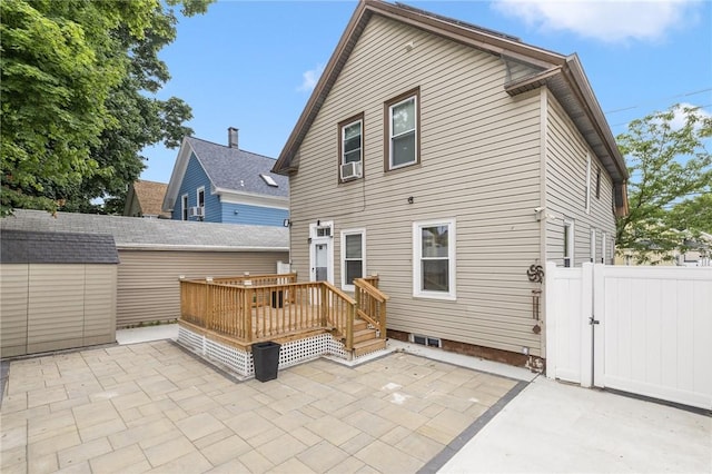155 Early St, Providence, RI 02907 - back of house featuring a patio area, a wooden deck, a gate, cooling unit, and an outbuilding
