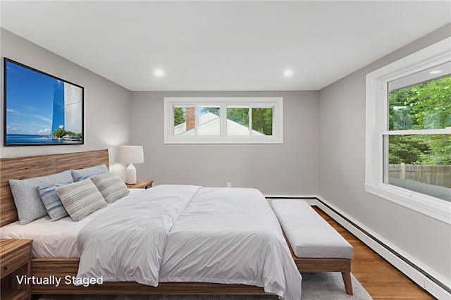 19 Cushing Rd, Warwick, RI 02888 - bedroom with baseboard heating, wood finished floors, multiple windows, and recessed lighting