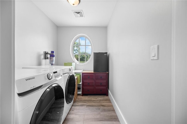 96 Evergreen St, Cumberland, RI 02864 - laundry room with washer and clothes dryer and light wood-style flooring