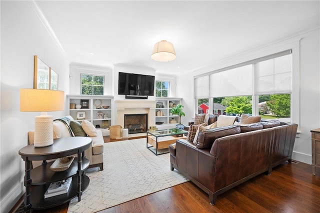 96 Evergreen St, Cumberland, RI 02864 - living area with plenty of natural light, a fireplace, crown molding, and wood finished floors