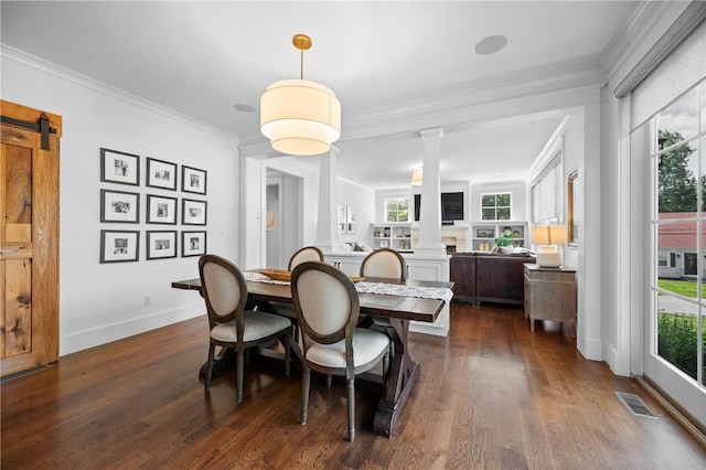 96 Evergreen St, Cumberland, RI 02864 - dining room featuring decorative columns, dark wood-style flooring, a barn door, and crown molding