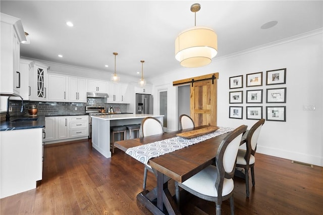 96 Evergreen St, Cumberland, RI 02864 - dining area with a barn door, ornamental molding, dark wood-style floors, and recessed lighting