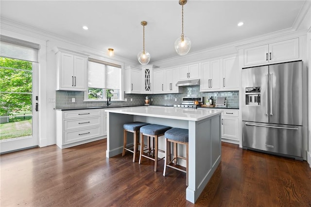 96 Evergreen St, Cumberland, RI 02864 - kitchen featuring high quality fridge, stove, white cabinets, a kitchen island, and crown molding