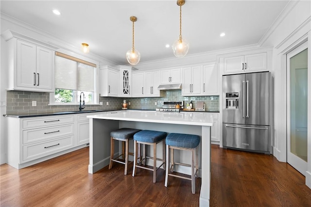 96 Evergreen St, Cumberland, RI 02864 - kitchen with high end fridge, range, under cabinet range hood, white cabinets, and crown molding