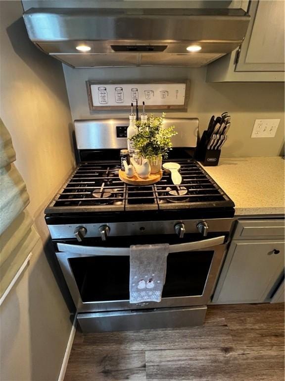 494 Putnam Pike Unit A12, Smithfield, RI 02828 - kitchen featuring stainless steel gas stove, wood finished floors, light countertops, and extractor fan