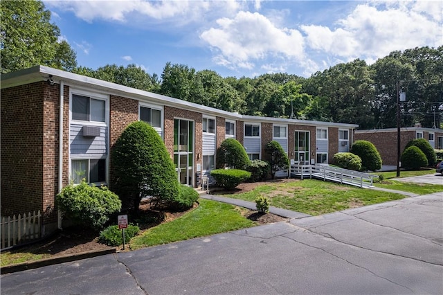 494 Putnam Pike Unit A12, Smithfield, RI 02828 - view of front facade with brick siding and a front yard