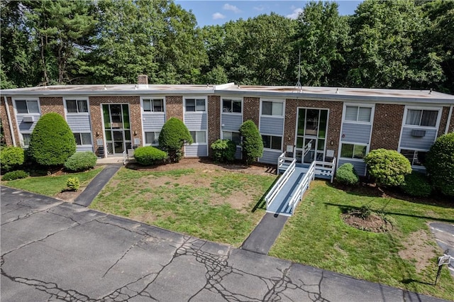 494 Putnam Pike Unit A12, Smithfield, RI 02828 - bi-level home with a front yard, brick siding, and a chimney