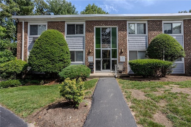 494 Putnam Pike Unit A12, Smithfield, RI 02828 - view of front of house featuring a front lawn and brick siding
