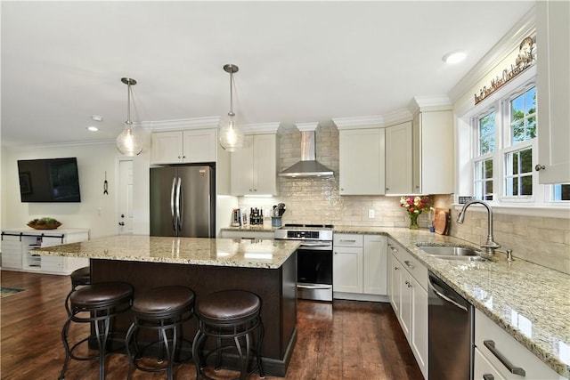 107 Pottersville Rd, Little Compton, RI 02837 - kitchen with appliances with stainless steel finishes, wall chimney range hood, dark wood finished floors, a kitchen breakfast bar, and ornamental molding
