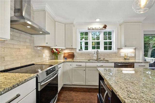 107 Pottersville Rd, Little Compton, RI 02837 - kitchen with wall chimney exhaust hood, appliances with stainless steel finishes, white cabinetry, plenty of natural light, and crown molding