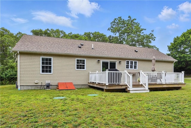 107 Pottersville Rd, Little Compton, RI 02837 - rear view of house featuring a wooden deck, a lawn, and a shingled roof