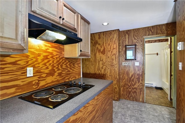 107 Pottersville Rd, Little Compton, RI 02837 - kitchen with under cabinet range hood, black electric cooktop, a baseboard radiator, and tile patterned flooring