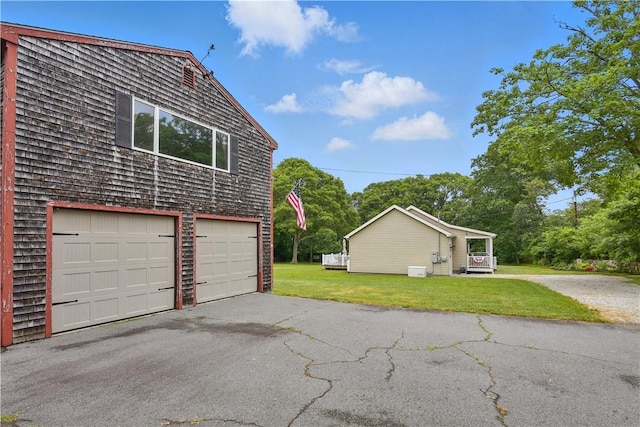 107 Pottersville Rd, Little Compton, RI 02837 - view of home's exterior with a lawn and asphalt driveway