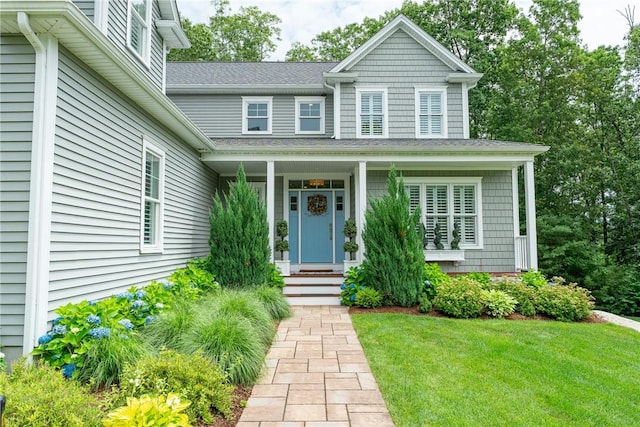 64 Knight View Dr, West Greenwich, RI 02817 - entrance to property with a shingled roof, a lawn, and a porch