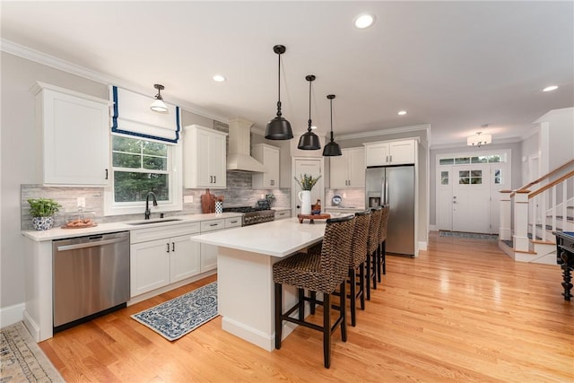 64 Knight View Dr, West Greenwich, RI 02817 - kitchen featuring appliances with stainless steel finishes, custom range hood, white cabinetry, ornamental molding, and recessed lighting