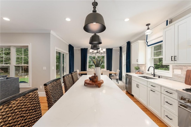 64 Knight View Dr, West Greenwich, RI 02817 - kitchen with ornamental molding, stainless steel appliances, light wood-type flooring, a chandelier, and decorative light fixtures