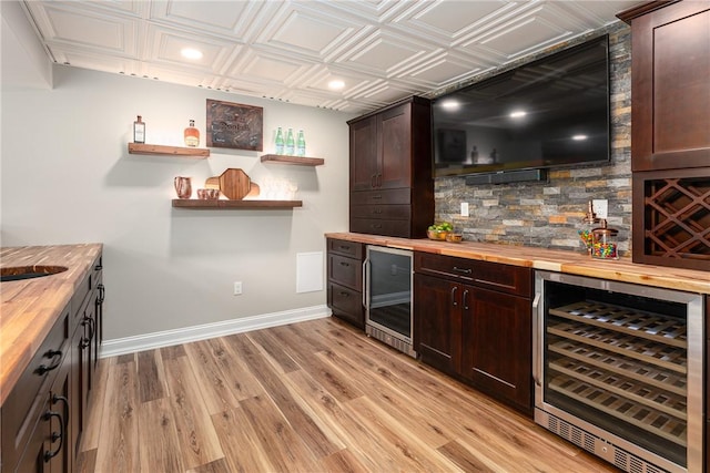 64 Knight View Dr, West Greenwich, RI 02817 - indoor dry bar featuring wine cooler, decorative backsplash, light wood-style flooring, recessed lighting, and an ornate ceiling