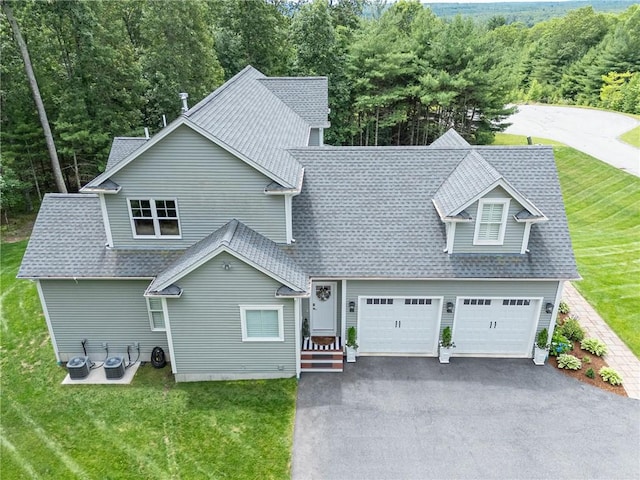 64 Knight View Dr, West Greenwich, RI 02817 - view of front of home with asphalt driveway, a front lawn, and a shingled roof