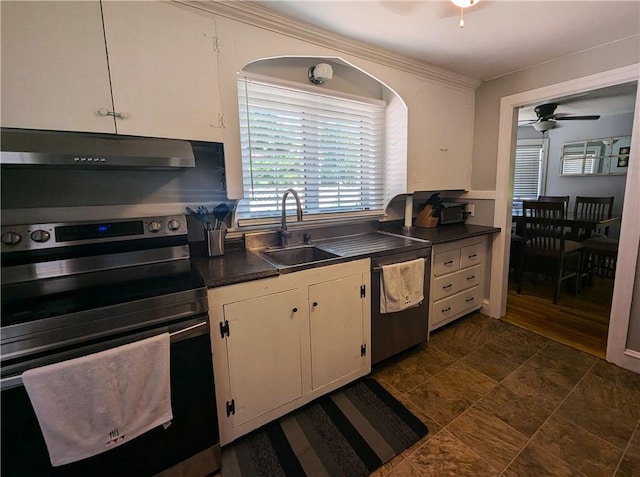 125 Roger Williams, East Providence, RI 02916 - kitchen featuring stainless steel appliances, under cabinet range hood, ceiling fan, dark countertops, and stone finish floors