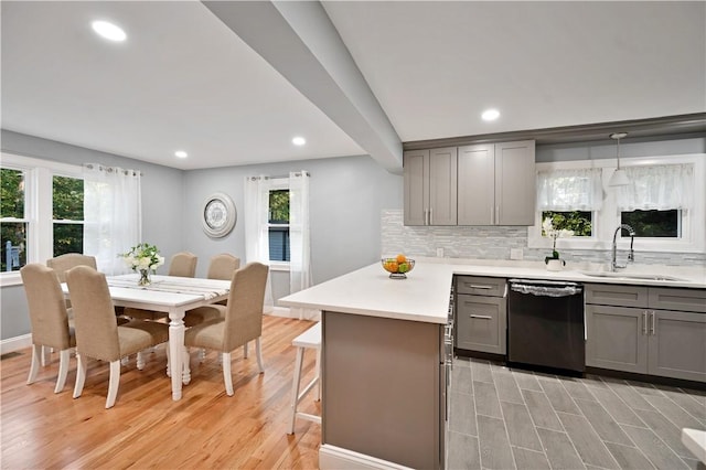 12 Leddy Rd, Cumberland, RI 02864 - kitchen with dishwashing machine, gray cabinetry, light wood-style flooring, a kitchen bar, and recessed lighting