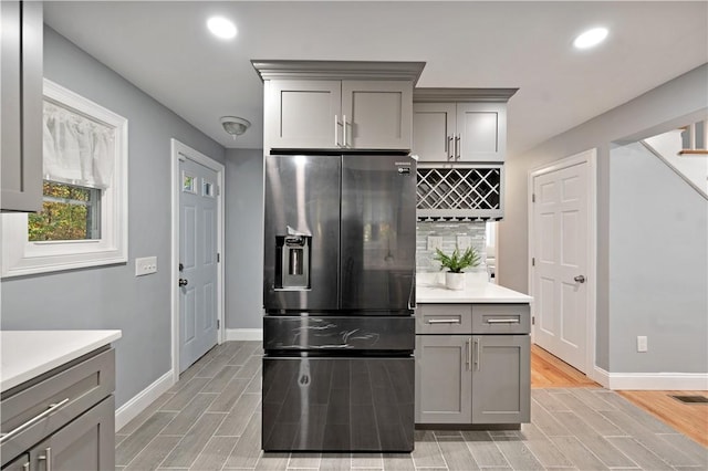 12 Leddy Rd, Cumberland, RI 02864 - kitchen with stainless steel refrigerator with ice dispenser, gray cabinets, wood finish floors, decorative backsplash, and recessed lighting