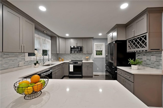 12 Leddy Rd, Cumberland, RI 02864 - kitchen with black appliances, gray cabinetry, backsplash, plenty of natural light, and recessed lighting