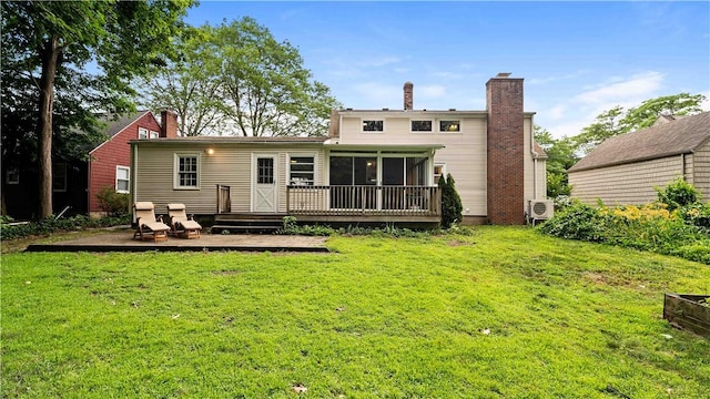74 Algonquin Rd, East Providence, RI 02916 - back of house with a deck, a chimney, a sunroom, and a lawn