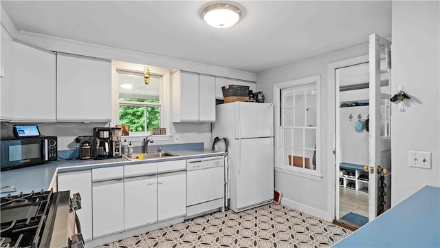 74 Algonquin Rd, East Providence, RI 02916 - kitchen with white appliances, white cabinets, light countertops, and light flooring