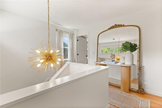 33 Arbor Dr Unit 27, Providence, RI 02908 - corridor featuring a chandelier and light wood-style flooring
