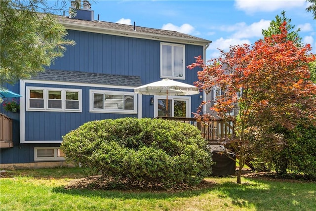 33 Arbor Dr Unit 27, Providence, RI 02908 - rear view of property with a shingled roof, a deck, and a chimney