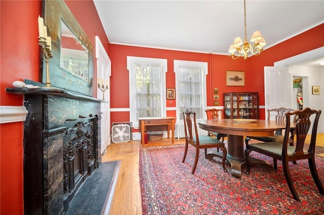 33 Kay St, Newport, RI 02840 - dining space with a high end fireplace, a chandelier, crown molding, and wood finished floors